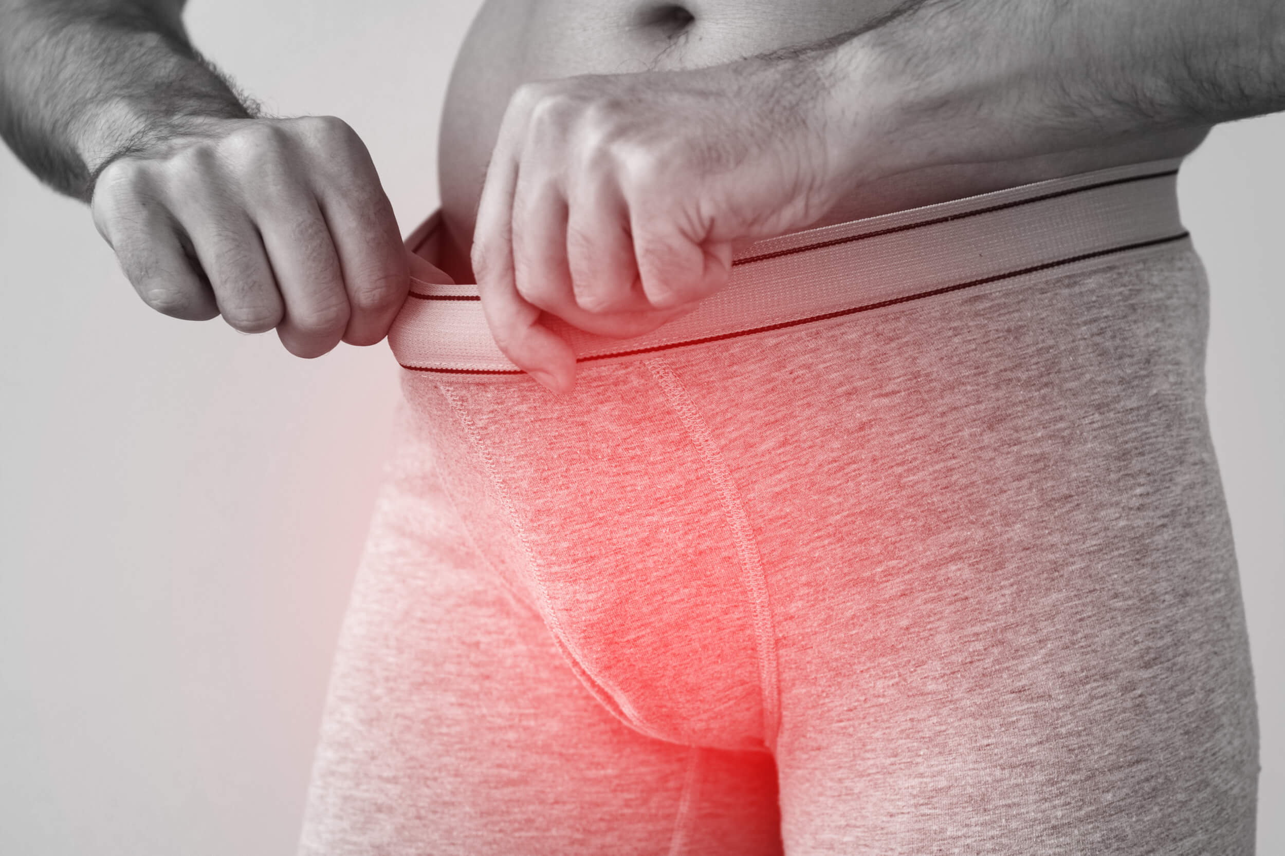 Young man man wearing briefs suffering from penile pain